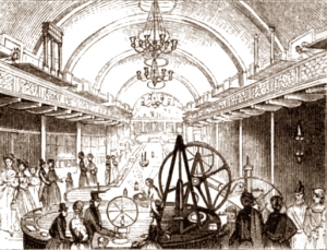 Visitors looking at apparatus in long galleried room